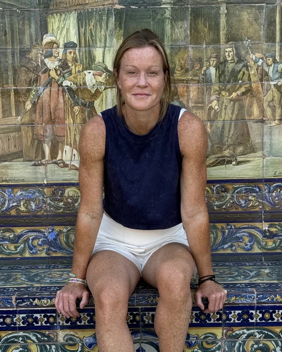 Kelly Lake sitting on a tiled bench in Seville